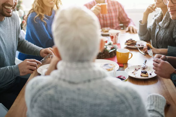 Stock image of a grandma at a table with family.
