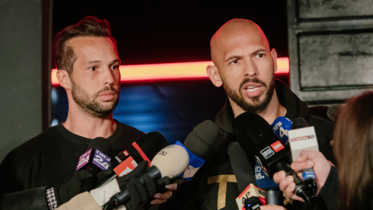 Andrew Tate and his brother Tristan Tate talk to the media outside of their residence on March 23, 2025, in Bucharest, Romania.