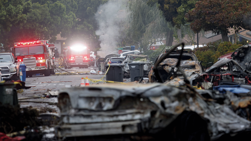 Firefighters work the site where a small plane crashed into a San Diego, California, residential street on Thursday.