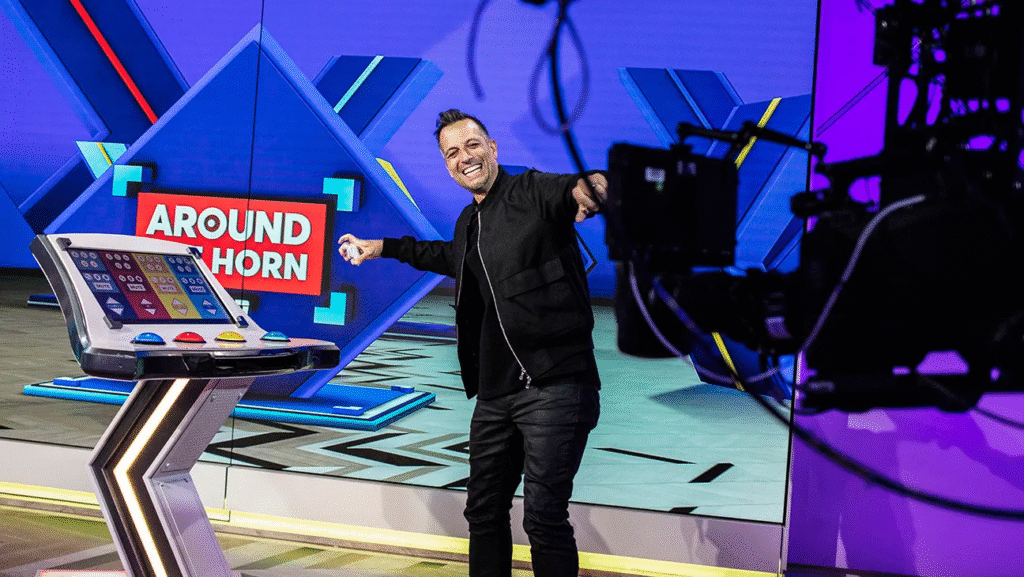 Tony Reali throws a wad of paper at the camera during the taping of ‘Around the Horn'