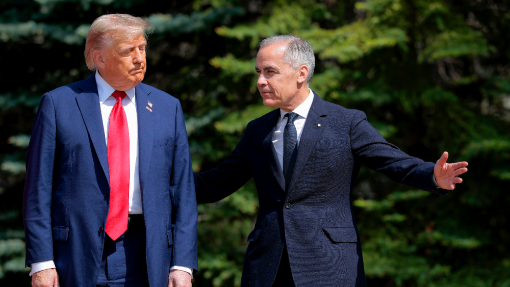 Canadian Prime Minister Mark Carney (R) greets U.S. President Donald Trump at the official welcome ceremony during the G7 Leaders' Summit on June 16, 2025.