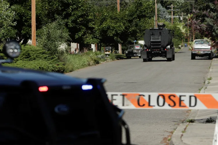 An armored police vehicle travels towards an area where multiple firefighters were attacked when responding to a fire in the Canfield Mountain area outside Coeur d'Alene, Idaho.